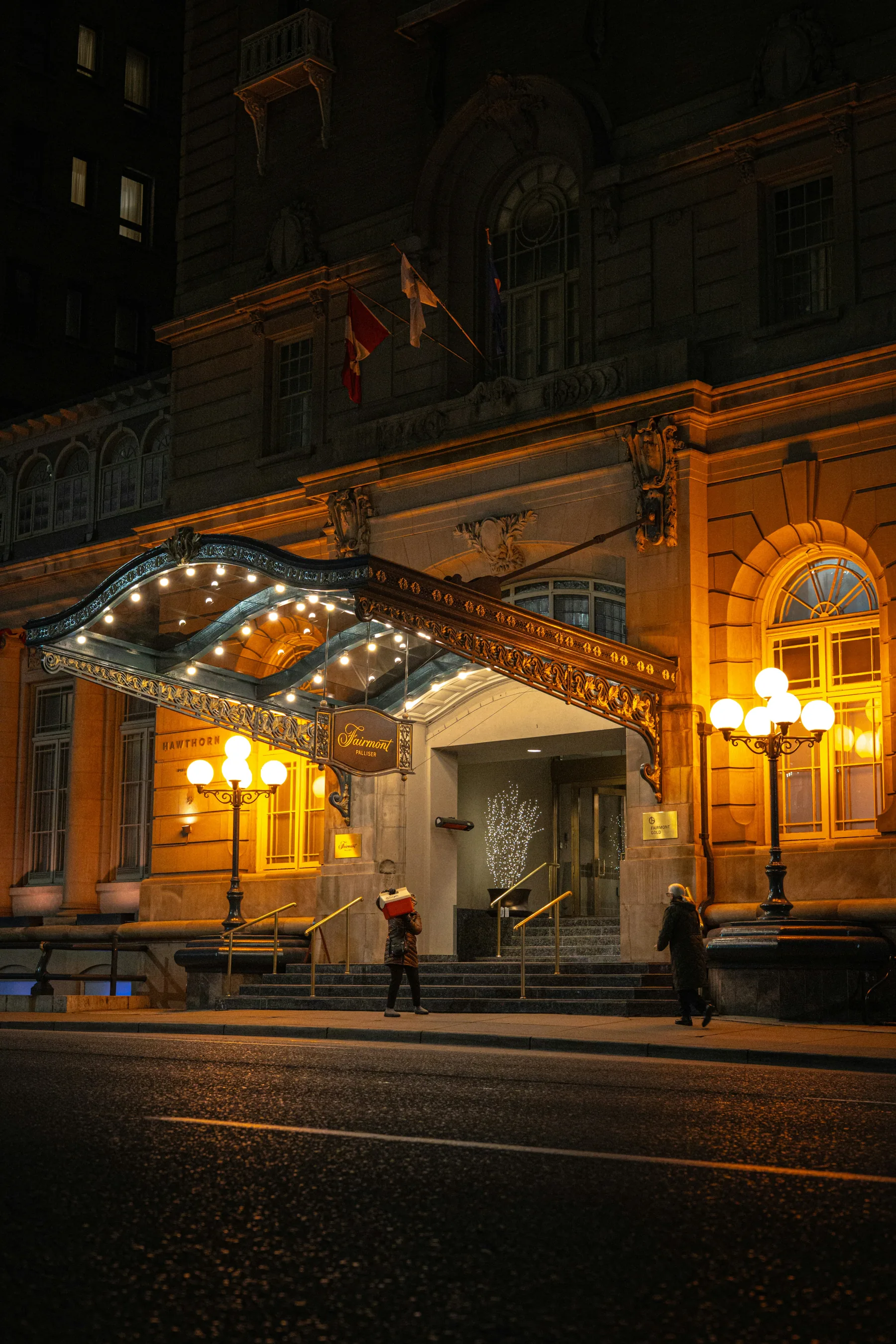 Illustrative hotel entrance illuminated at night